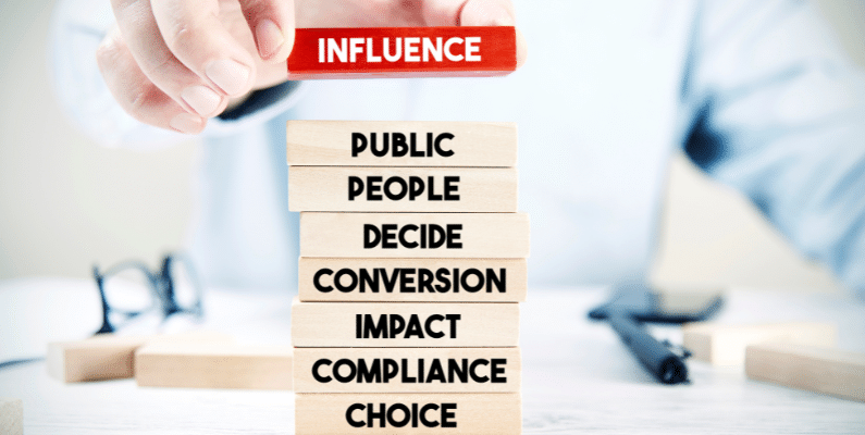 Stack of blocks with influence words influences on workplace decision making