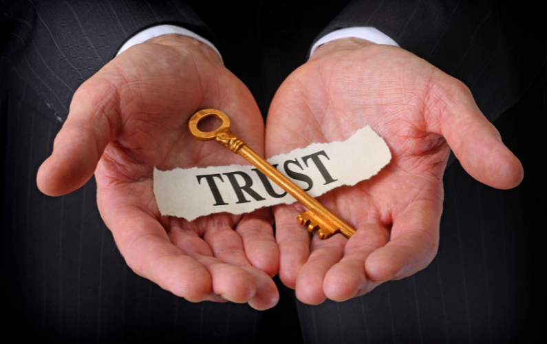 Concept of Trust in ERP Success - Hands Holding a Gold Key and a Paper Labeled Trust