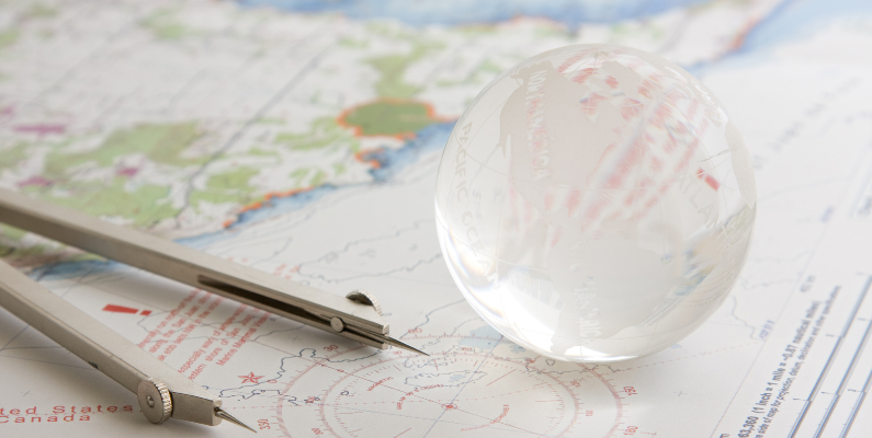 Image of navigating with a map and a crystal ball in referencing that navigating AI in ERP is uncharted territory. There are both opportunities and risks in this journey