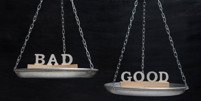 Scale with the words 'Good' and 'Bad' hanging from chains against a dark background, symbolizing the dual impacts of AI.