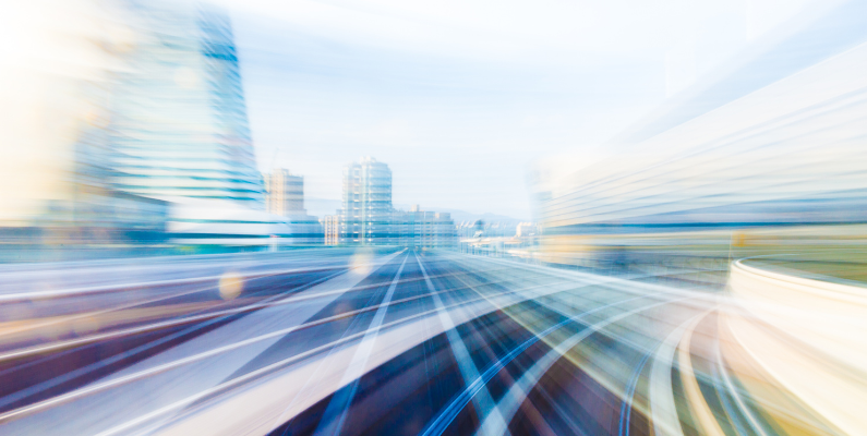 image of a fast pace of movement through a brightly colored modern city landscape representing the fast pace of Artificial Intelligence Enabled ERP
